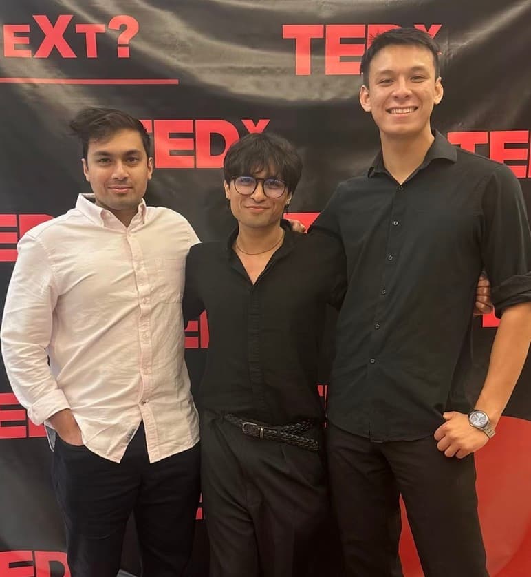 Rafan with two people at a TEDx event